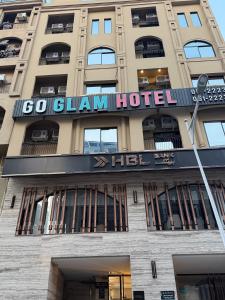 a building with a sign on top of it at Go Glam Hotels Bahria Town in Rawalpindi