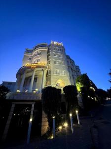 a large building with lights on it at night at Kanaan Group Hotel in Baalbeck