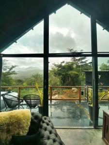 a living room with a large glass window with a view at Cabana Pegasus in Ibicoara