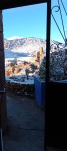 a door with a view of the desert from a room at Maison Ighrem in Idoukaln +6 photos