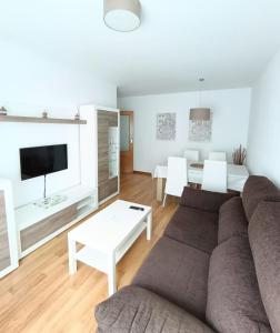 a living room with a couch and a table at La Escapada, muy cerca de Llanes in Llanes