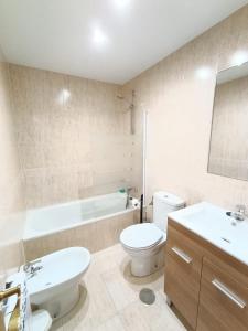 a bathroom with a toilet and a sink and a tub at La Escapada, muy cerca de Llanes in Llanes +17 photos