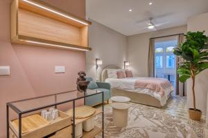 a hotel room with a bed and a bed and a window at NORFOLK Suites in Sliema