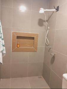 a bathroom with a shower with a wooden shower head at 3 A A a in Sinop