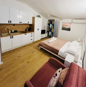 a small bedroom with a bed and a kitchen at Apartments Mateljak in Gradac