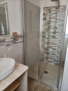a bathroom with a shower and a sink at La casa di Nonna Carta in Fordongianus +30 photos