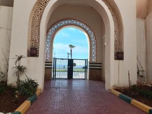 an archway in a building with a view of the ocean at Cosy appart 3p in Rabat