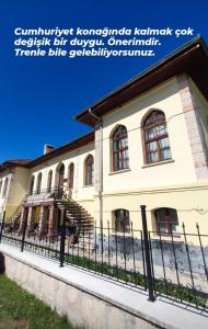 a building with a fence in front of it at Frig Evi in Sabuncu