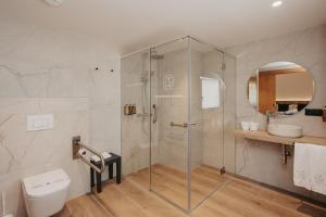 a bathroom with a shower and a toilet at La Trobada Hotel Sport in Ripoll +75 photos