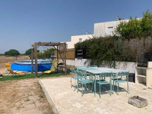 a patio with a table and chairs and a pool at Sublime Sun & Van - By Meco Stays in Alfarim