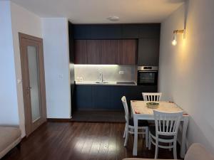a kitchen with a table and chairs in a room at Podgorica Royal Apartment in Podgorica