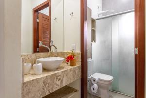 a bathroom with a sink and a toilet at Refúgio Gostoso in São Miguel do Gostoso +45 photos