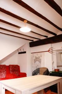 a living room with a red couch and a table at Casa del Puente in Nerpio