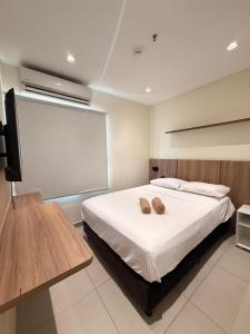 a bedroom with a bed with two shoes on it at Molas 112B in Asunción
