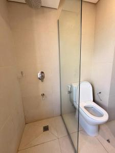 a bathroom with a toilet and a glass shower stall at Molas 112B in Asunción +8 photos