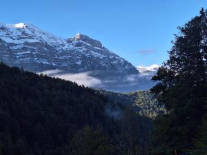 a mountain covered in snow and clouds in a valley at Ferienwohnung Rüf in Bizau