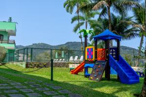 a playground in a park with a slide at Marencanto Pousada in Ubatuba