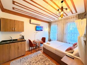 a bedroom with a bed and a sink and a table at April Mansion in Istanbul
