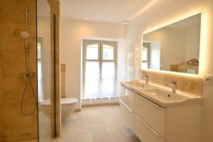 a bathroom with a sink and a toilet and a mirror at Chambres d'hôtes de La Tour Morillon in Saint-Amand-Montrond +22 photos