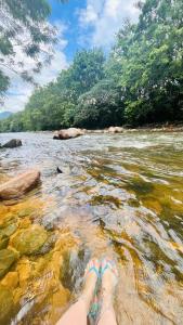a person with their feet in a body of water at Rancho300 - Quiriri - Joinville in Joinville
