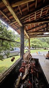 a grill with a bunch of hot dogs on it at Rancho300 - Quiriri - Joinville in Joinville