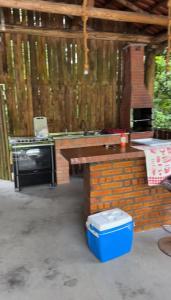 an outdoor kitchen with a stove and a sink at Rancho300 - Quiriri - Joinville in Joinville