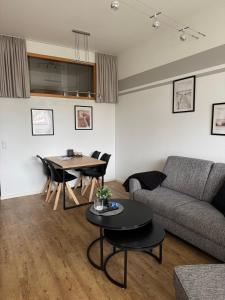 a living room with a couch and a table at Ferienwohnung Fehmarn am Südstrand in Fehmarn