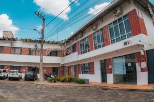 a building with cars parked in front of it at VILLA BILAC - Large Studios close to Vila Germânica in Blumenau