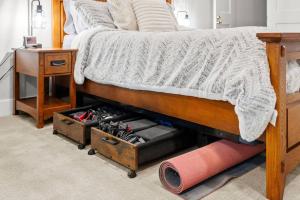 a bedroom with a bed with a drawer under it at Tranquil Retreat: Pool, Spa, Firepit, Peloton, WFH in Orangevale +20 photos