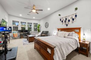 a bedroom with a bed and a tv and a desk at Tranquil Retreat: Pool, Spa, Firepit, Peloton, WFH in Orangevale
