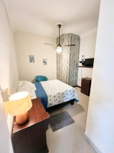 a small bedroom with a bed and a table at The Boat House in Boca Chica