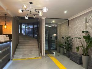 a lobby with a staircase leading to a building at Khan Boutique Hotel in Almaty