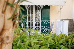 a house with a green door and a fence at Corfu Bay Serenity Suite in Ágios Rókkos