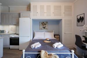 a bedroom with a bed with towels on it at Corfu Bay Serenity Suite in Ágios Rókkos