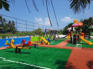a playground with a slide and swings at Thundi Villa in Maalhos