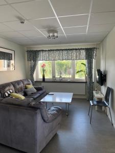 a living room with a couch and a table at Partille Vandrarhem in Partille