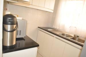a kitchen with a coffee maker and a sink at RosiMug's Homestay in Umtali