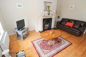 a living room with a leather couch and a table at Aisling in Foxford