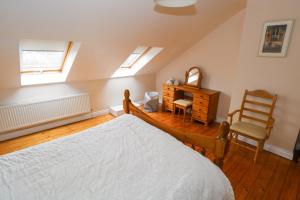 a bedroom with a bed and a chair and a dresser at Aisling in Foxford