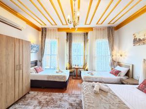 a bedroom with two beds and a chandelier at April Mansion in Istanbul