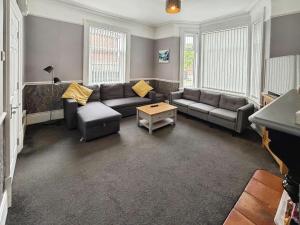 a living room with a couch and a table at Winwood House in Goole