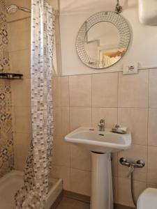 a bathroom with a sink and a mirror at Affittacamere Fulginiae in Foligno