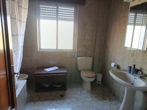 a bathroom with a sink and a toilet and a sink at A Ribeira in Fene