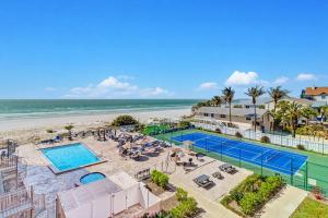 an aerial view of a pool and the beach at Reef Club 304 in Clearwater Beach