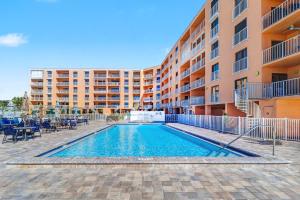 a swimming pool in front of a apartment building at Reef Club 304 in Clearwater Beach