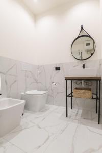a bathroom with a tub and a toilet and a sink at Dimora Costa Cefalù in Cefalù