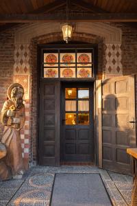 a front door of a house with a statue next to it at Pensjonat u Bernackich in Smołdzino