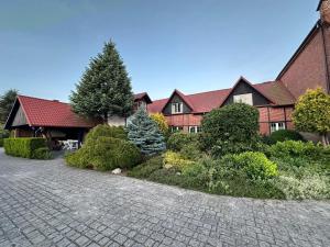 a house with a brick driveway in front of it at Pensjonat u Bernackich in Smołdzino