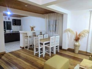 a kitchen and dining room with a table and chairs at villa EMMANUEL -2 in Belanitra