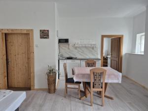 a kitchen and dining room with a table and chairs at Alte Post - Sonne in Gurk